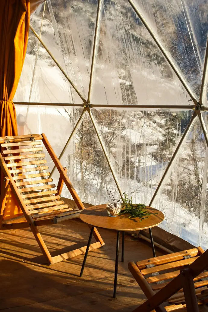 brown wooden folding chairs inside a glass room